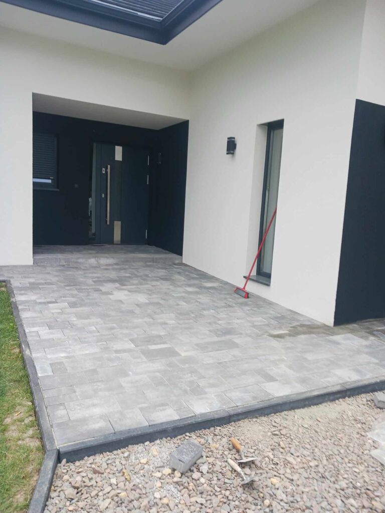 a white and black house with a red hose